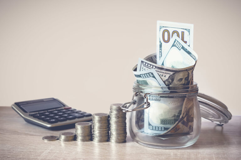 Coins Stack, calculator and US dollar bills in the glass jar. Concept of money saving, financial. Savings money and income Investment ideas and financial management for the future. Close up. Business Growth concept. Financial risk