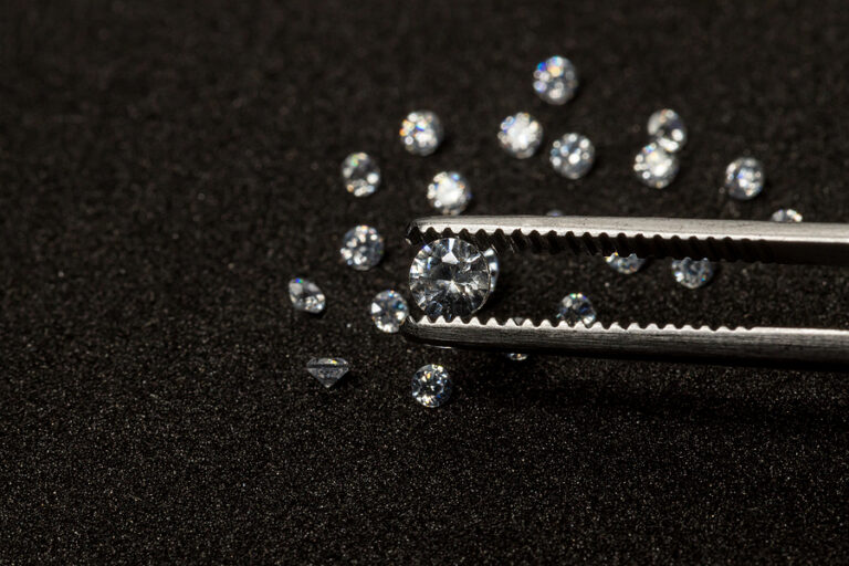 Diamonds are valuable, expensive and rare. For making jewelry. brilliant cut diamond held by tweezers. Beautiful diamond stone in tongs
