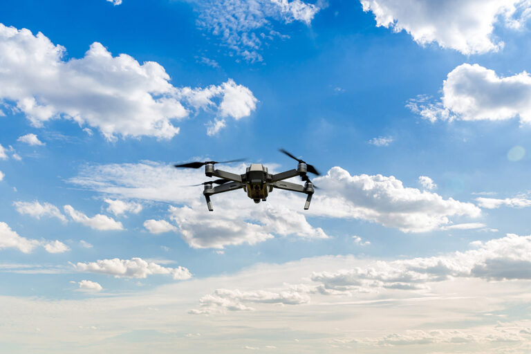 Drone copter flying with digital camera. Drone with high resolution digital camera. Flying camera take a photo and video. The drone with professional camera takes pictures of the misty mountains
