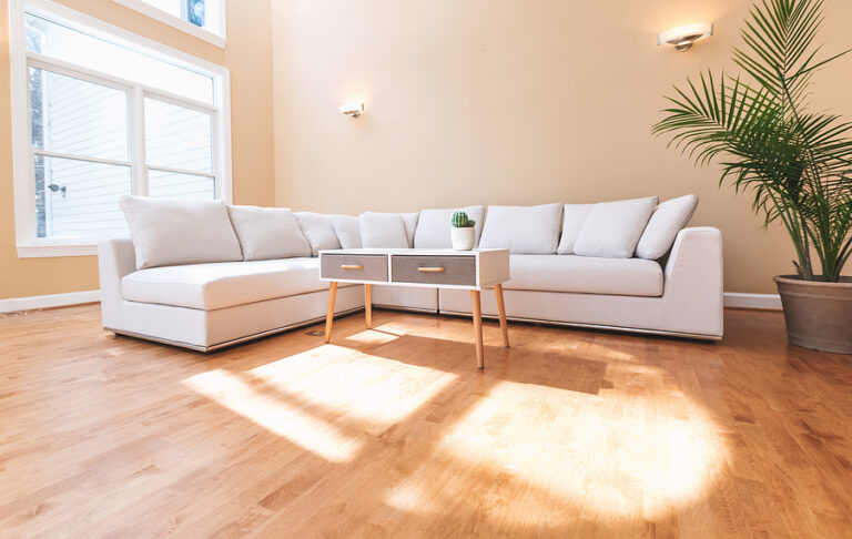 White sectional sofa couch in a large luxury interior home
