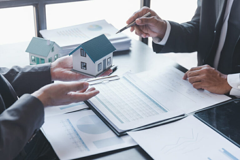 Business property,real estate and investment concepts. Real estate agent present terms of the home purchase agreement to customer,investor discussing real estate investment